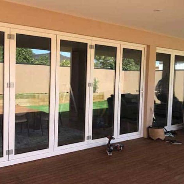 White UPVC bi-fold doors opened across a covered deck
