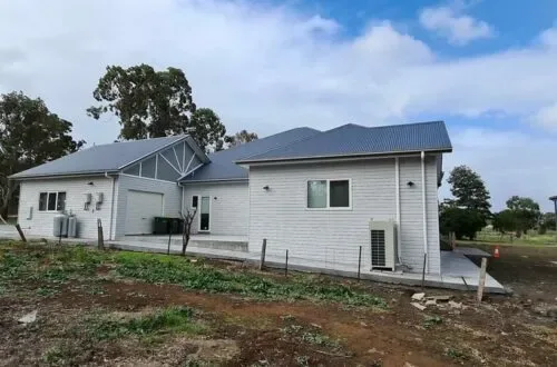 Completed weatherboard home with UPVC windows, near the garage