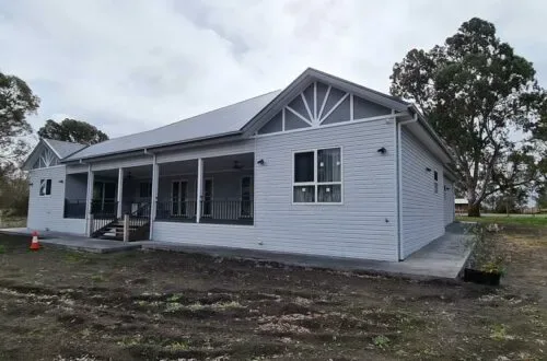 Completed weatherboard home with UPVC windows, rear view