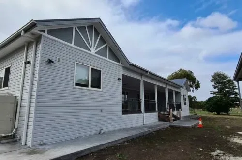 Completed weatherboard home with UPVC windows, verandah view
