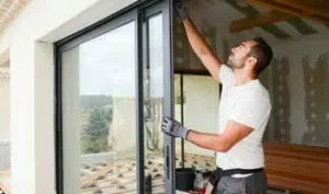 Installer fitting a UPVC sliding door on site