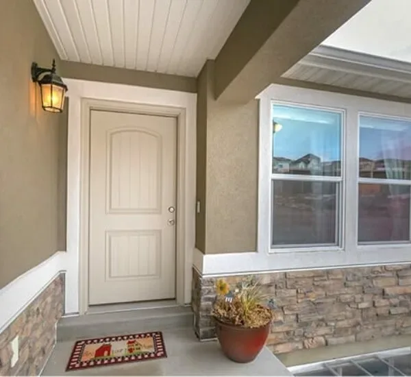 UPVC entry door and window on a covered home porch
