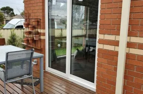 White UPVC sliding door installed on a brick home patio