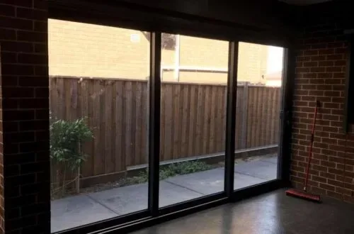 UPVC stacker door opening onto a fenced backyard