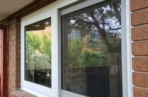 UPVC sliding window installed on a brick home exterior