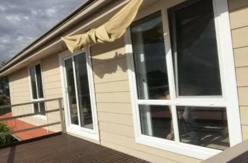 UPVC windows and glazed door opening onto a timber balcony